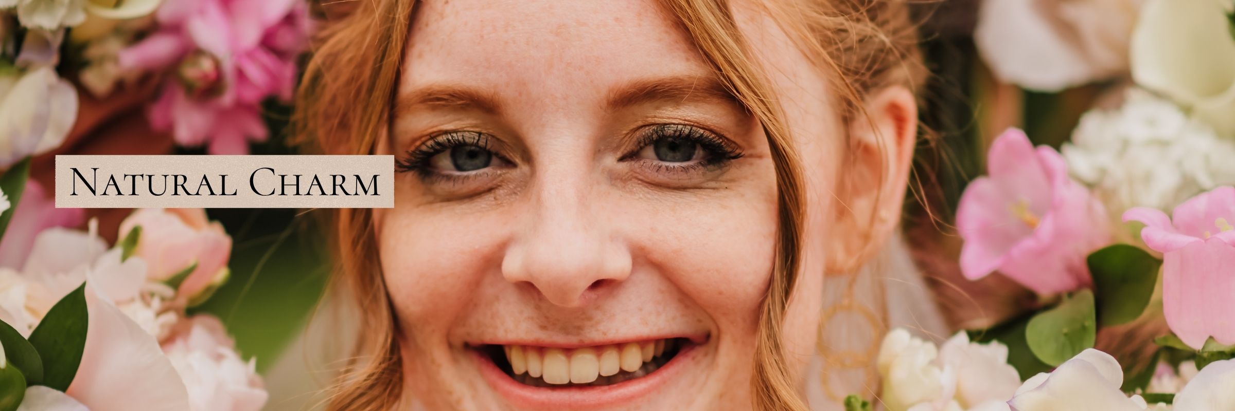 Bride's smiling face framed by a ring of bridesmaids and flowers